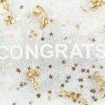 gold and silver confetti with the word congrats surrounded by confe